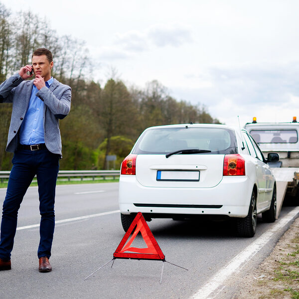 man calling beside the road
